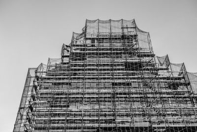 Building wrapped in construction scaffolding