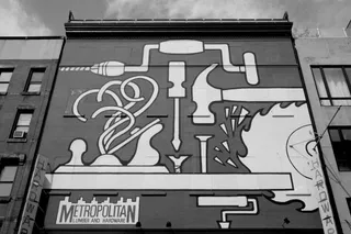 Large mural on side of building depicting various tools