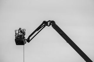 Workmen in a construction crane basket