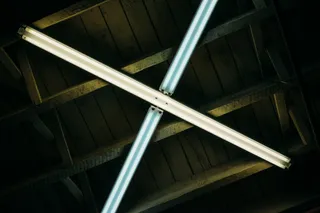 Two overhead fluorescent lights crossed in an X shape