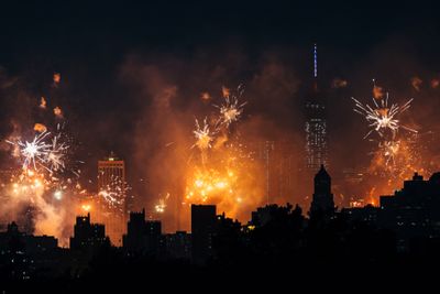 Fireworks exploding over New York City skyline
