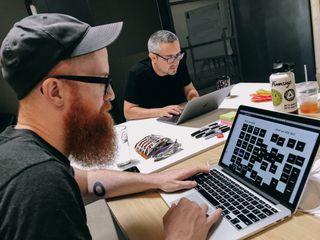 Rob Weychert (left) and Anthony Armendariz working on laptops