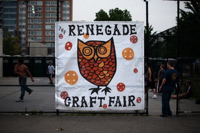 Renegade Craft Fair mural attached to fence surrounding handball court