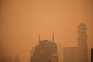 Building rooftops in Manhattan’s Soho neighborhood under orange-tinted sky