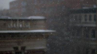 Slow motion video with shallow depth of field of snowflakes falling