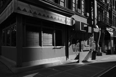 Black and white street view of the corner Watts Street and Sixth Avenue in Manhattan